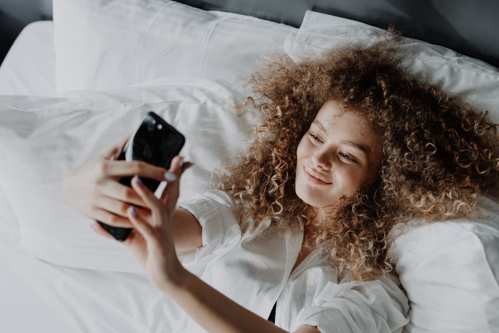 girl taking a selfie in bed