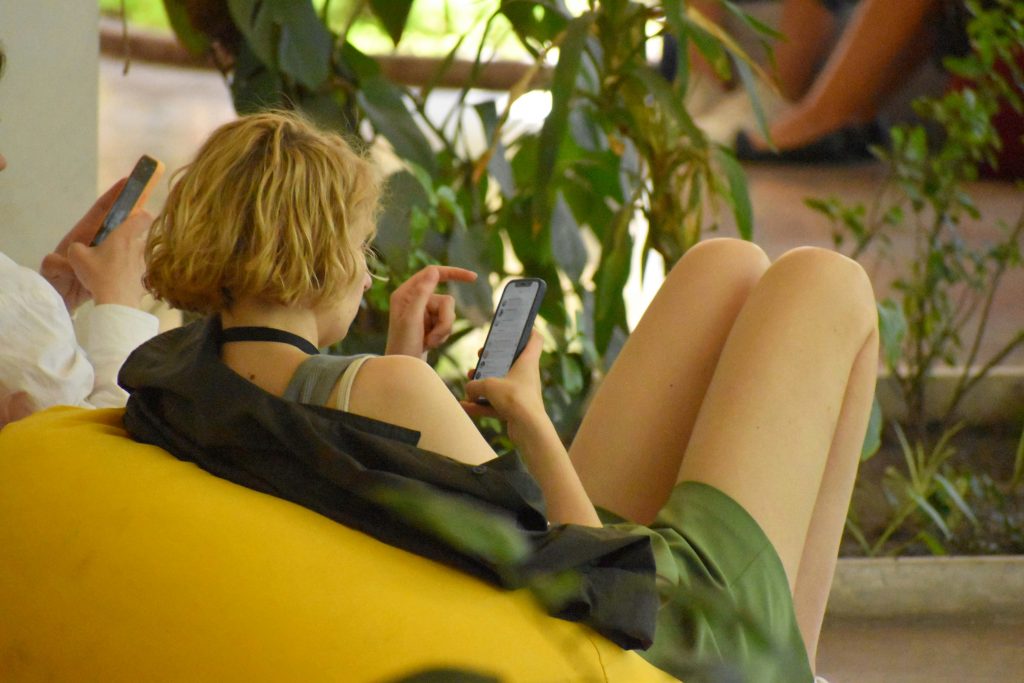 Person searching on phone — how to find someone on Fansly using a Fansly finder