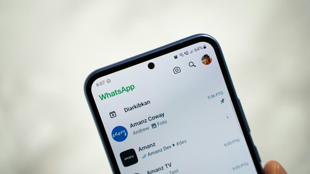 A smartphone displaying the WhatsApp chat list interface, representing how to use WhatsApp reverse image search to verify photos and identify who is behind a WhatsApp profile.
