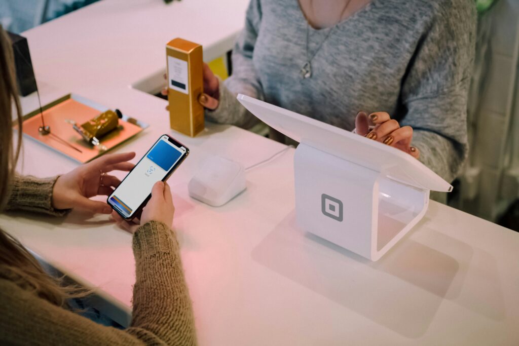 Person using Apple Pay on iPhone at point of sale terminal — how to verify identity on Apple Pay