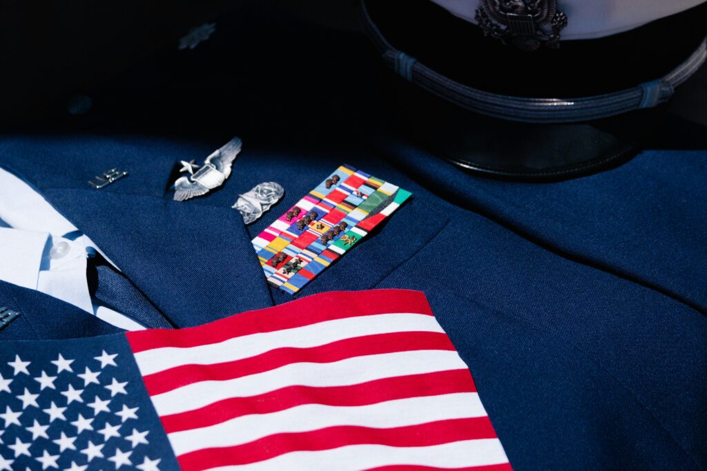 US military dress uniform with service ribbons, badges, and American flag — how to check military service records free