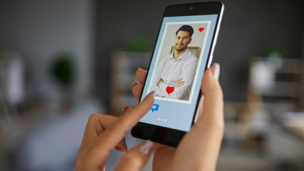 Woman swiping through a dating app profile with photo and heart icons on her phone