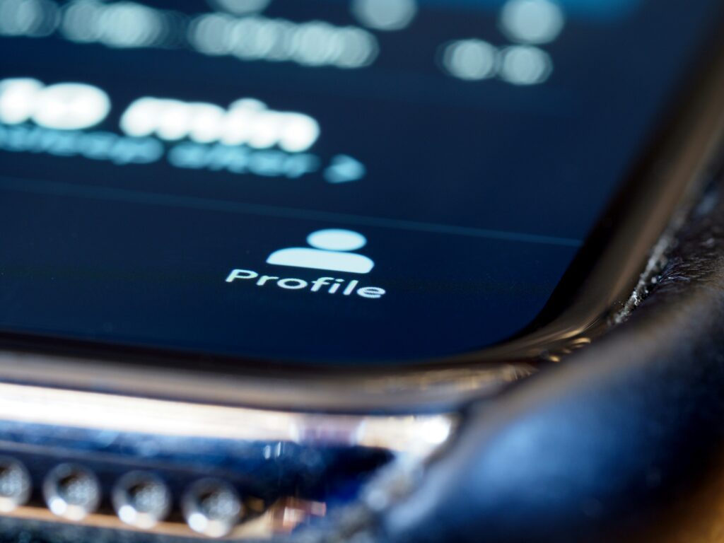 Profile icon on phone screen — how to tell if an online profile is AI generated or fake