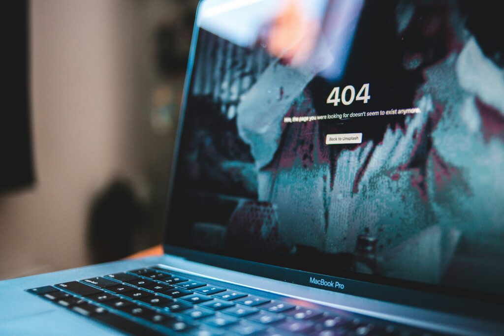 Laptop showing 404 error page — unverified identity sources and fake profiles online