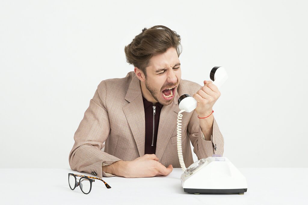 man getting frustrated because he got a scam text from a scammer