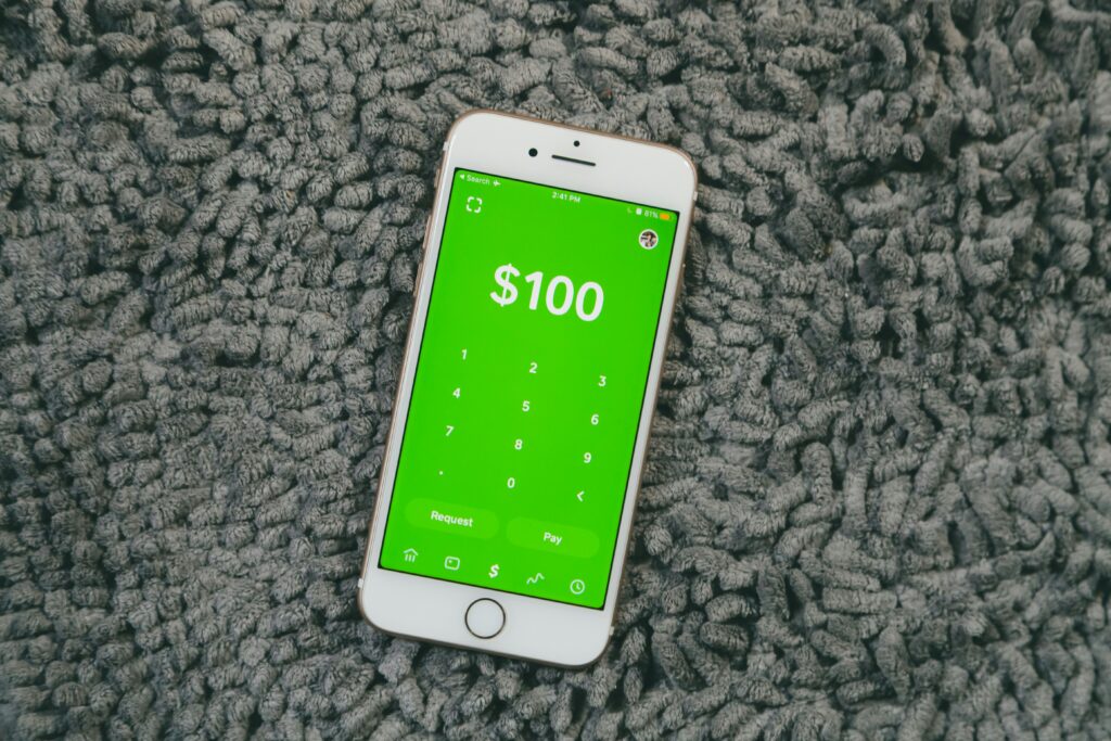 iPhone showing Cash App payment screen with $100 — verify Cash App identity before sending money to avoid scams