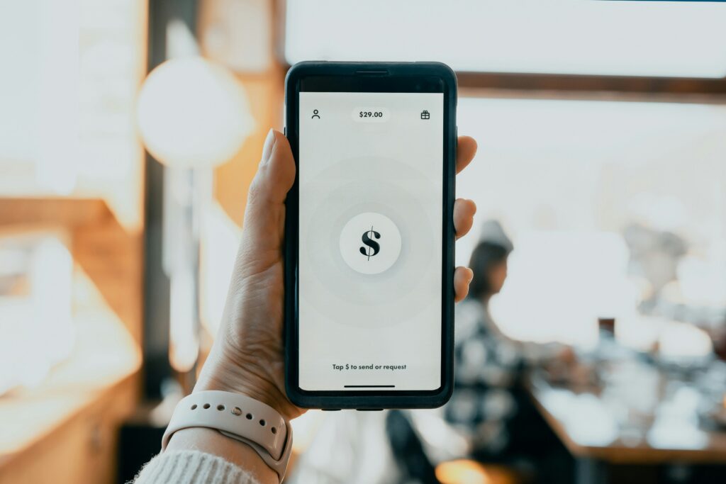 Person holding phone with Cash App send and request screen — how to verify a Cash App account is real