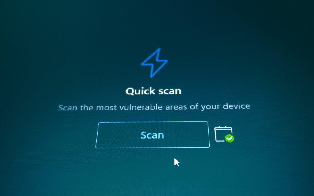 Close-up of a computer screen showing a "Quick scan" security tool interface with a scan button and a green checkmark icon.